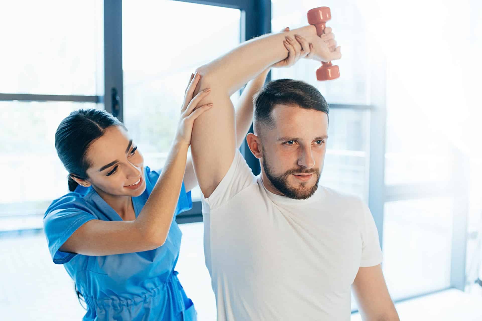 man using weights for sports injury treatment with doctor and Health and Wellness Care