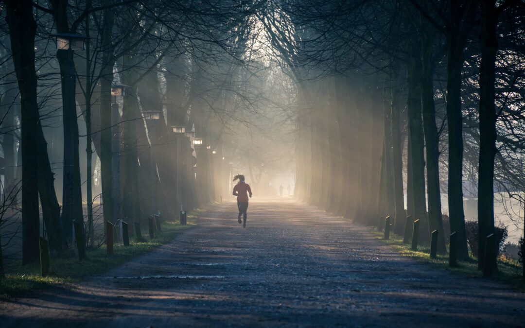 woman on a jog down a path in a park