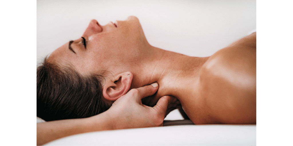 A practitioner’s hands gently treating and massaging a patient’s neck to relieve muscle tightness and tension headaches. This highlights the evidence-informed chiropractic care and massage therapy services available at Port Perry Wellness Centre to support physical and mental well-being.