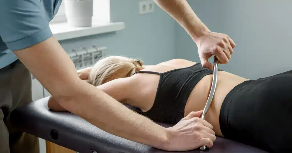 Therapist applying soft tissue therapy along back muscle and fascia lines at Port Perry Wellness Centre.